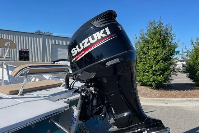 Slide: The Image of Suzuki outboard motor on 2017 Intruder 23 boat, parked outdoors. - 10