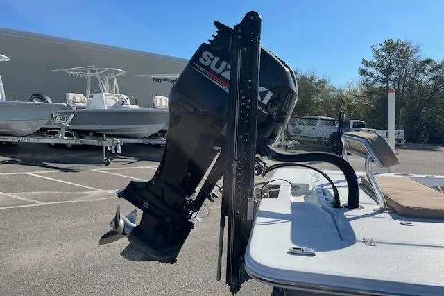 Slide: The Image of Boat with Suzuki outboard motor, Intruder 23 model, 2017, parked outdoors. - 11