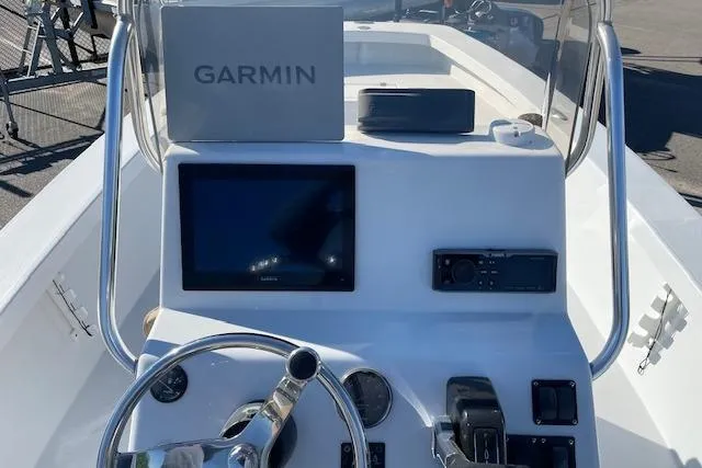 Slide: The Image of 2017 Intruder 23 boat dashboard with Garmin navigation system and steering wheel. - 12