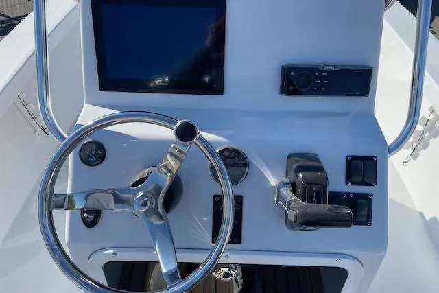 Slide: The Image of Steering console of a 2017 Intruder 23 boat with modern controls and display. - 13