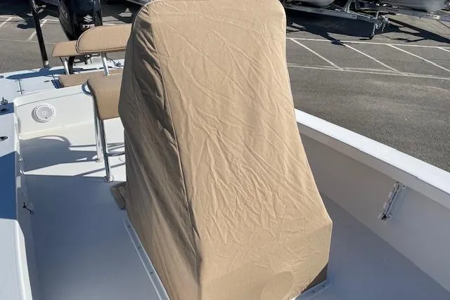Slide: The Image of 2017 Intruder 23 boat with covered console, parked in a lot. - 14