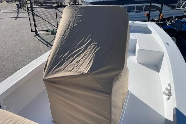 Slide: The Image of 2017 Intruder 23 boat with covered console, docked in a marina. - 15