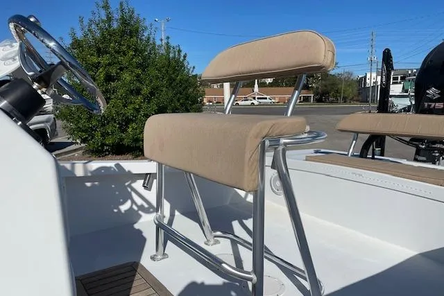 Slide: The Image of 2017 Intruder 23 boat interior with beige seating and steering wheel. - 6