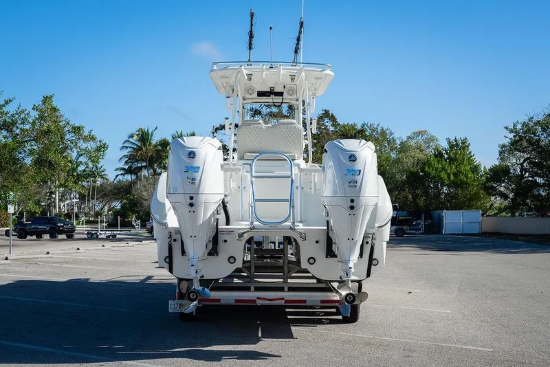 Slide: The Image of 2024 World Cat 295 CC boat with dual outboard engines in a parking lot. - 14