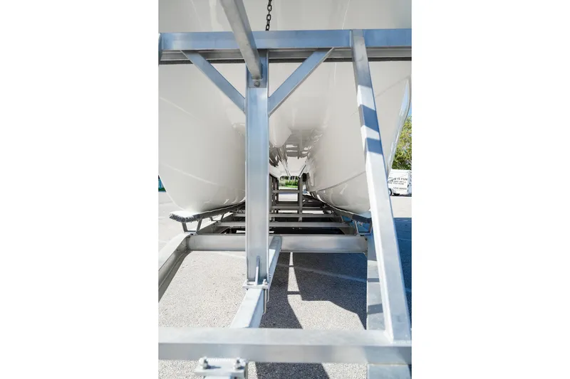 Slide: The Image of 2024 World Cat 295 CC boat hull on trailer, showcasing underside structure. - 19