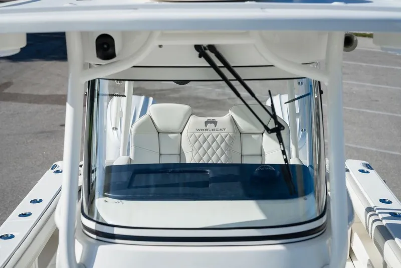Slide: The Image of 2024 World Cat 295 CC boat interior with windshield and seating view. - 26