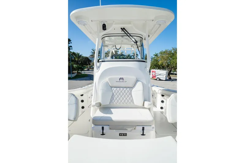 Slide: The Image of 2024 World Cat 295 CC boat interior with white seating and helm station. - 27