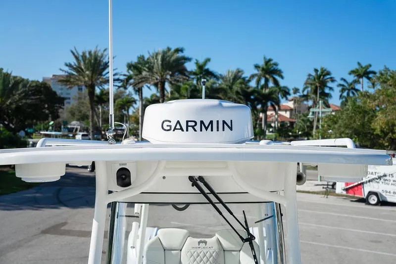 Slide: The Image of 2024 World Cat 295 CC boat with Garmin radar, palm trees in background. - 29