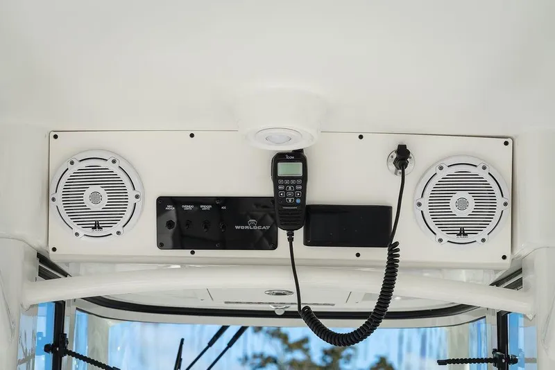 Slide: The Image of 2024 World Cat 295 CC boat dashboard with speakers and communication equipment. - 33