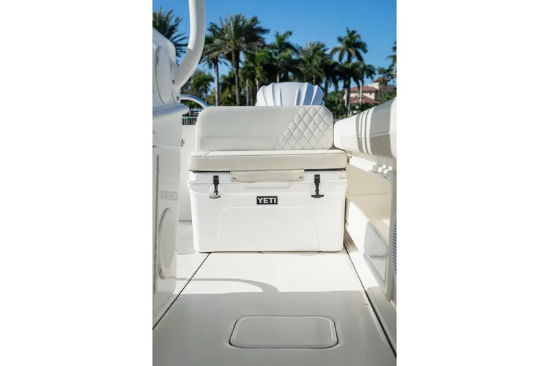 Slide: The Image of 2024 World Cat 295 CC boat interior with Yeti cooler and cushioned seating. - 35