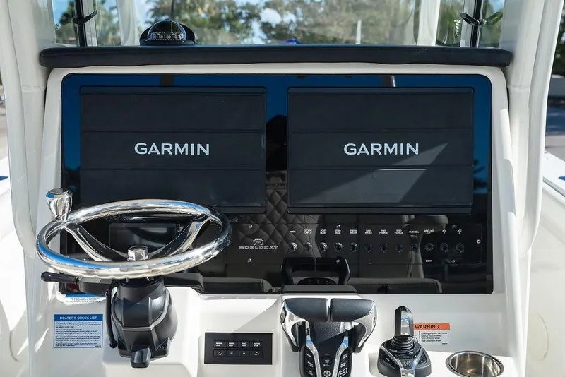 Slide: The Image of 2024 World Cat 295 CC dashboard with dual Garmin displays and steering wheel. - 36