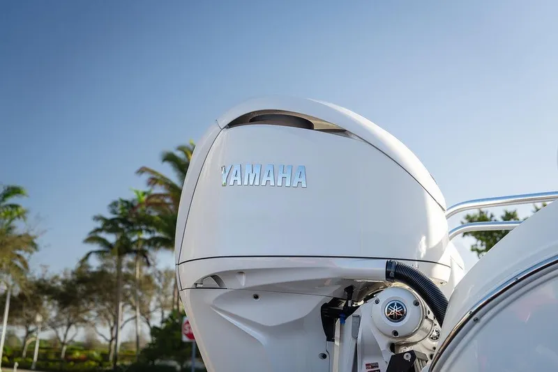 Slide: The Image of 2024 World Cat 295 CC with Yamaha outboard motor, palm trees in background. - 46