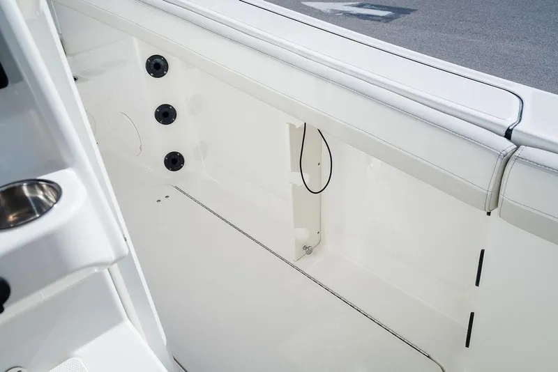Slide: The Image of 2024 World Cat 295 CC boat interior, featuring sleek white seating and modern design elements. - 49