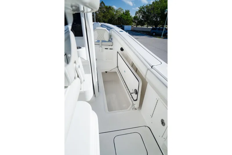 Slide: The Image of 2024 World Cat 295 CC boat interior with open storage compartment, showcasing sleek design. - 55