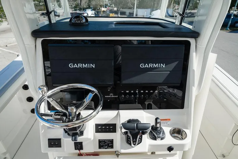 Slide: The Image of 2024 World Cat 295 CC helm with Garmin displays and modern controls. - 57