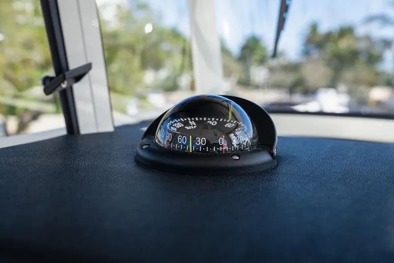 Slide: The Image of Compass on 2024 World Cat 295 CC boat dashboard, indicating direction. - 58