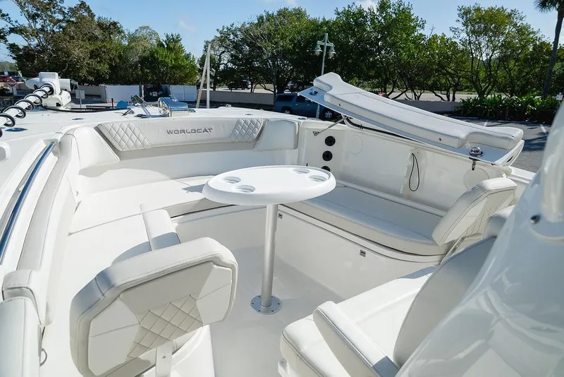 Slide: The Image of 2024 World Cat 295 CC boat interior with white seating and round table. - 60