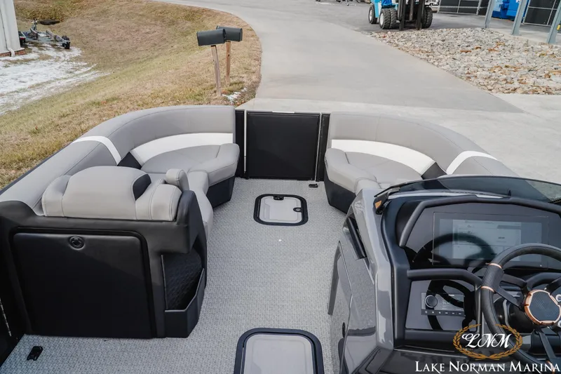 Slide: The Image of Interior of 2026 Evotti 723QL boat with modern seating and steering console at Lake Norman Marina. - 13