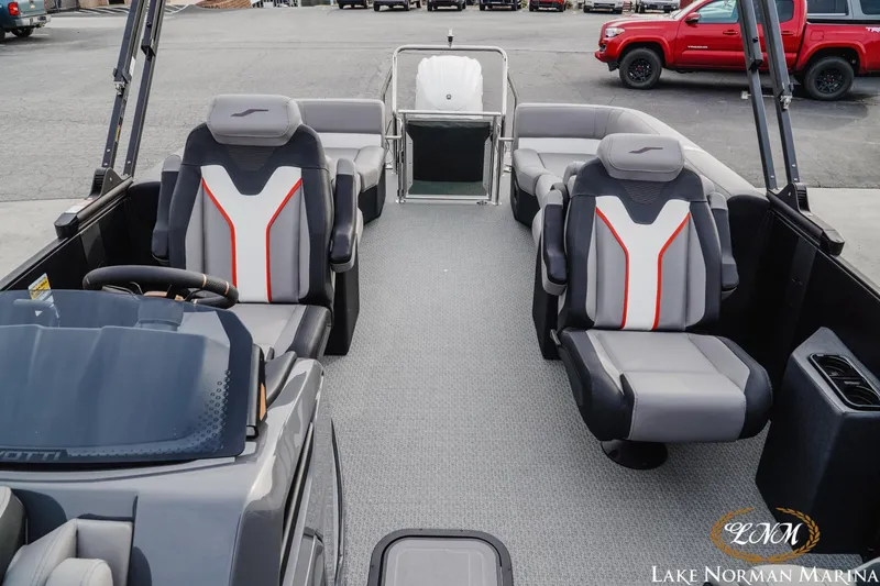 Slide: The Image of Evotti 723QL 2026 boat interior with modern seating and steering wheel at Lake Norman Marina. - 19