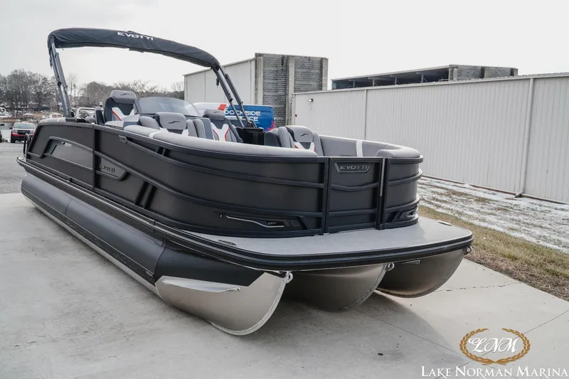 Slide: The Image of 2026 Evotti 723QL pontoon boat at Lake Norman Marina, featuring sleek black design and spacious seating. - 5
