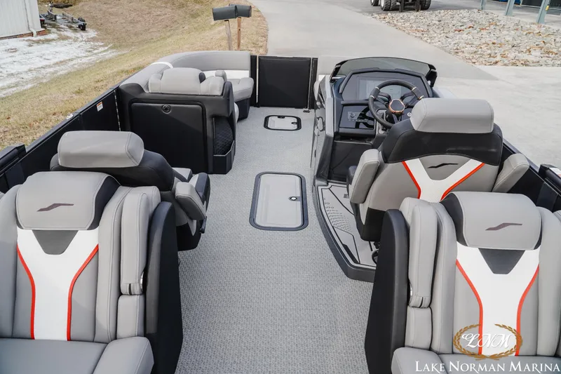 Slide: The Image of 2026 Evotti 723QL boat interior with modern seating and steering console at Lake Norman Marina. - 9