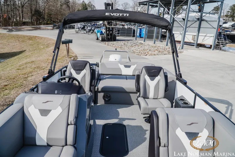 Slide: The Image of 2026 Evotti 521CS boat interior at Lake Norman Marina, featuring modern seating and steering. - 11