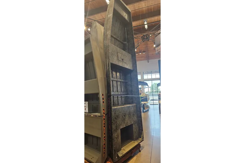 The Image of 2026 Tracker Grizzly 15 Jon boat displayed vertically in a showroom. - 0