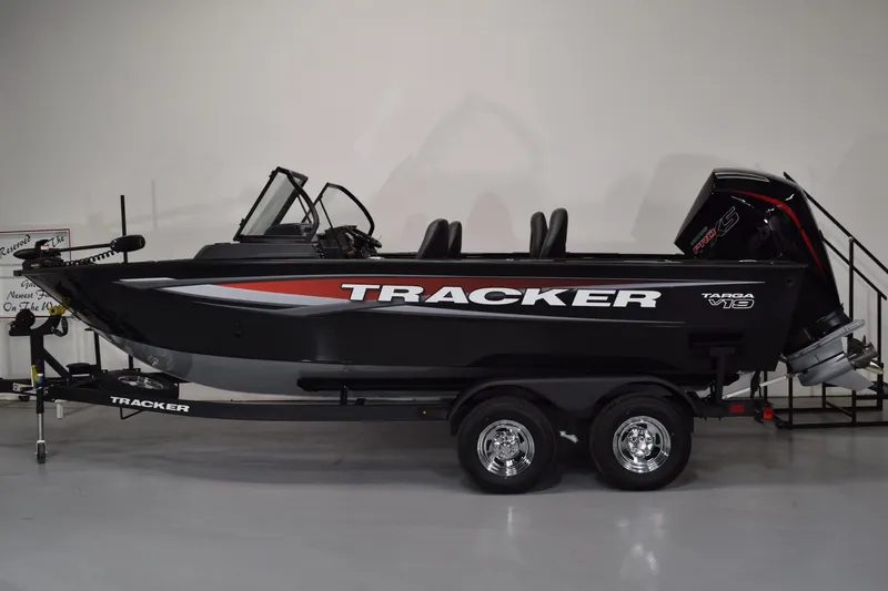 The Image of 2026 Tracker Targa V-19 Combo boat on trailer, black with red accents, side view. - 0