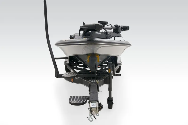 Slide: The Image of Open storage compartment in 2026 Triton 21XP Patriot boat, featuring carpeted surfaces and metal latches. - 15