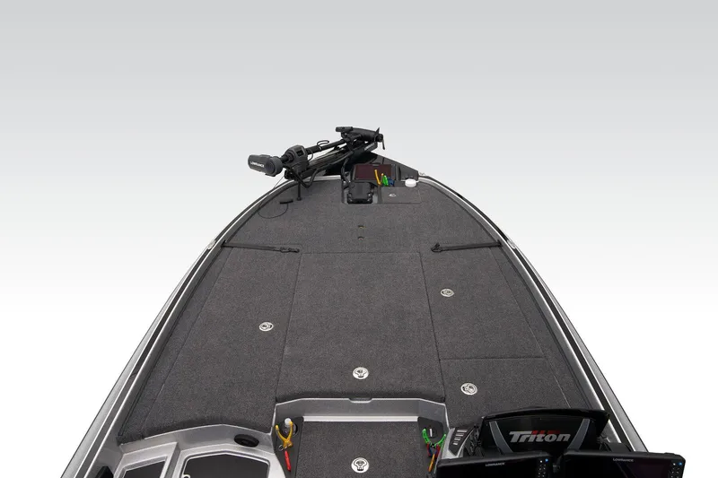 Slide: The Image of 2026 Triton 21XP Patriot boat interior with Lowrance electronics and Triton-branded seats. - 26