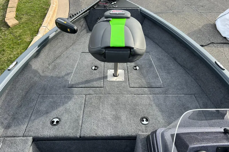 Slide: The Image of 2026 Ranger VS1665SC boat interior with gray carpet and green-accented seat. - 4