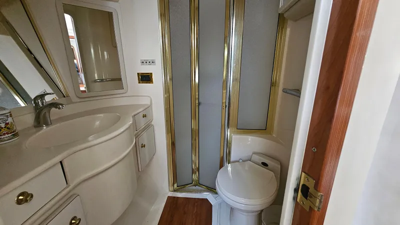 Slide: The Image of Luxurious bathroom in 1999 Sea Ray 500 Sundancer yacht with shower, sink, and toilet. - 31