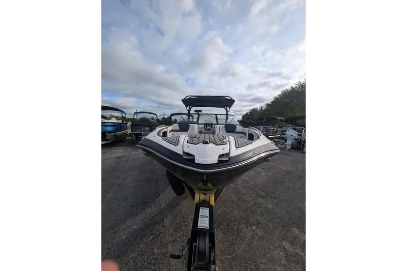 Slide: The Image of 2014 Yamaha Boats 242 Limited S on trailer under cloudy sky. - 3