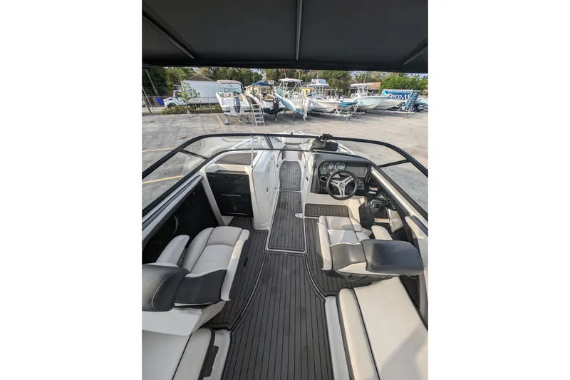Slide: The Image of 2014 Yamaha Boats 242 Limited S interior with sleek seating and modern dashboard. - 7