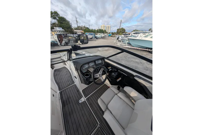 Slide: The Image of Interior view of 2014 Yamaha Boats 242 Limited S, showcasing steering and seating area. - 9
