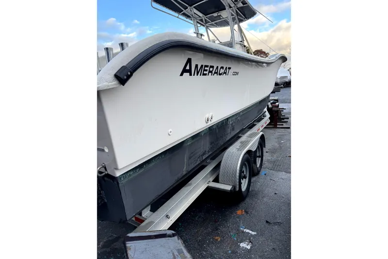Slide: The Image of 2015 AmeraCat 27 boat on trailer, white hull, outdoor setting. - 2