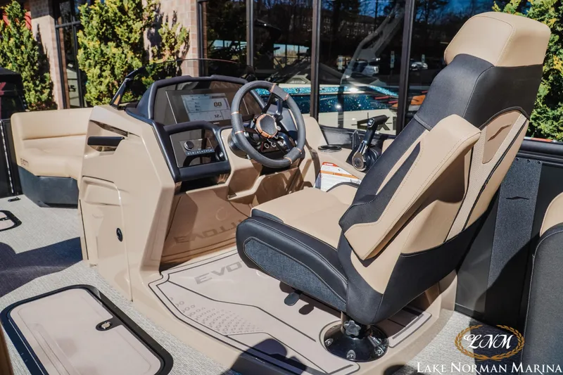 Slide: The Image of Interior of 2026 Evotti 723QL boat at Lake Norman Marina, featuring modern helm and seating. - 12