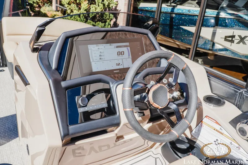 Slide: The Image of Cockpit of 2026 Evotti 723QL boat with modern steering and digital display. - 14