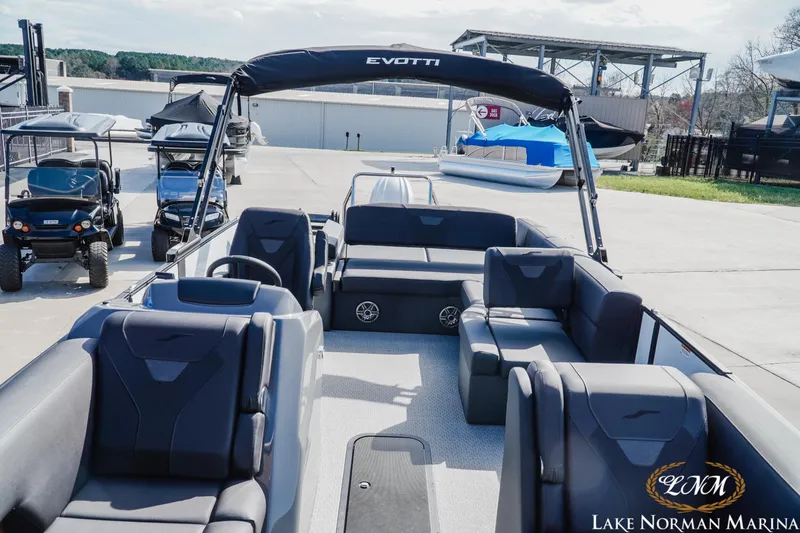 Slide: The Image of Evotti 523CS 2026 model pontoon boat at Lake Norman Marina, featuring luxurious seating. - 12
