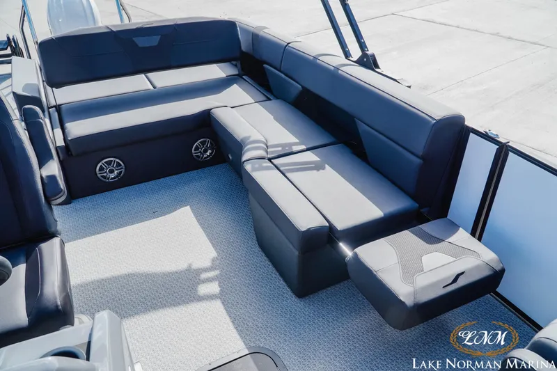 Slide: The Image of 2026 Evotti 523CS boat interior with luxurious seating and integrated speakers at Lake Norman Marina. - 17