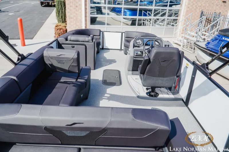 Slide: The Image of 2026 Evotti 523CS boat interior with modern seating and steering console at Lake Norman Marina. - 5