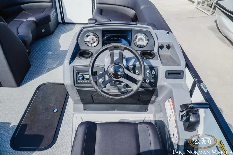 Slide: The Image of Cockpit of 2026 Evotti 523CS boat with modern steering and controls at Lake Norman Marina. - 9