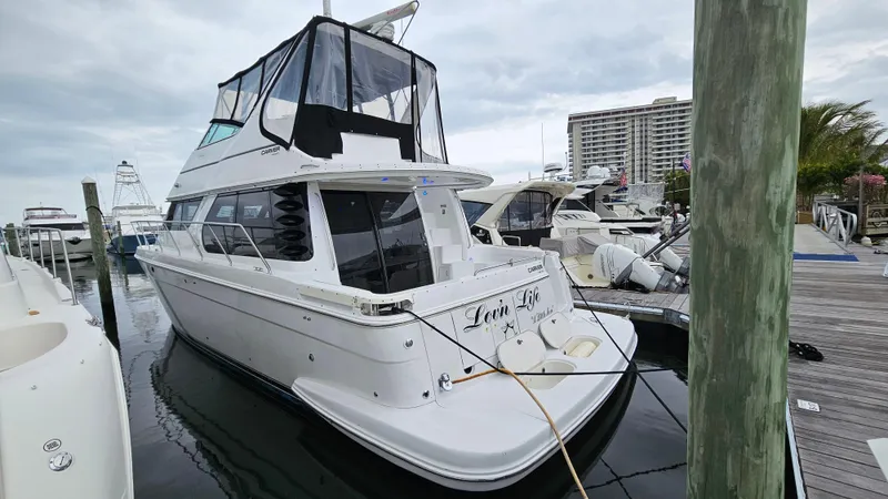 Slide: The Image of 2000 Carver 450 Voyager Pilothouse yacht docked at marina, overcast sky. - 13