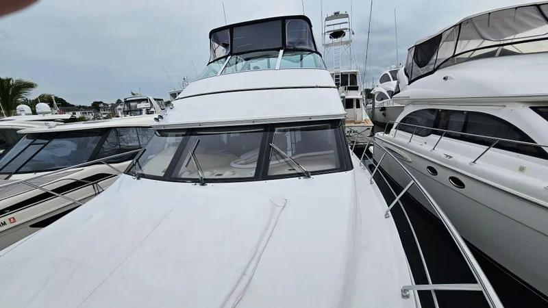 Slide: The Image of 2000 Carver 450 Voyager Pilothouse yacht docked at marina, front view. - 17