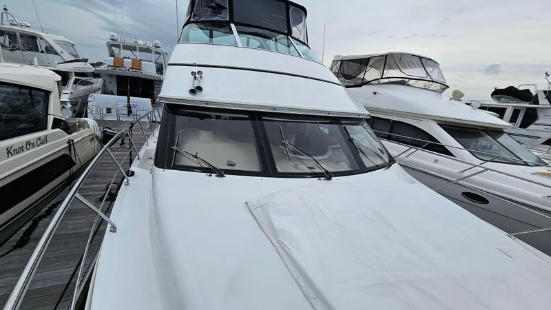 Slide: The Image of 2000 Carver 450 Voyager Pilothouse yacht docked among other boats. - 18