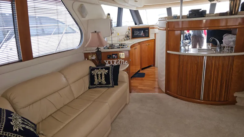 Slide: The Image of Interior of 2000 Carver 450 Voyager Pilothouse with beige sofa and wooden cabinetry. - 25