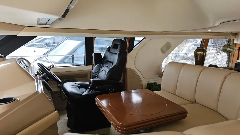 Slide: The Image of Interior of 2000 Carver 450 Voyager Pilothouse with leather seating and wooden table. - 35
