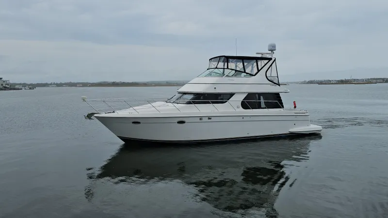 Slide: The Image of 2000 Carver 450 Voyager Pilothouse yacht cruising on calm waters. - 4
