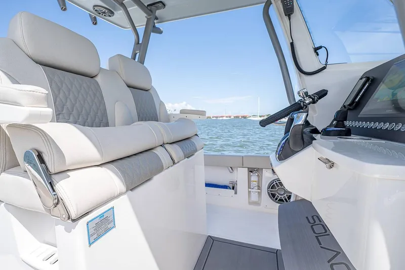 Slide: The Image of Manufacturer Provided Image: Interior of 2026 Solace 28 HCS boat with luxurious seating and modern controls. - 4