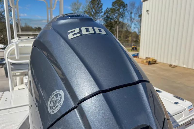 Slide: The Image of 2025 Robalo 226 Cayman boat with a 200 horsepower engine, outdoor setting. - 2